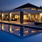 View of pool and patio area, with water apartment, architecture, estate, evening, home, hotel, house, landscape lighting, leisure, lighting, night, property, real estate, reflection, resort, sky, swimming pool, villa, water, window, blue