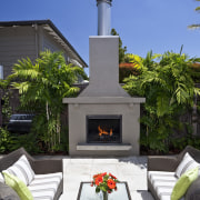 View of outdoor entertainment area, with pool, spa, home, outdoor structure, patio, real estate, blue