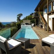 View of pool and spa area with wooden deck, estate, home, house, leisure, outdoor furniture, outdoor structure, property, real estate, resort, sunlounger, swimming pool, villa, black