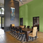 View of a dining room which features wall architecture, ceiling, chair, dining room, floor, flooring, furniture, interior design, living room, lobby, real estate, room, table, wall, wood flooring, brown