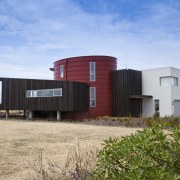 View of red, black and white beach house architecture, facade, home, house, property, real estate, sky, teal