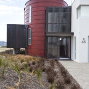 View of red, black and white beach house architecture, building, facade, home, house, real estate, sky, white
