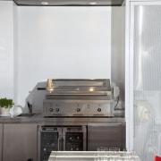 View of an outdoor kitchen which features a furniture, home appliance, interior design, kitchen, kitchen appliance, kitchen stove, white