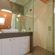 View of bathroom suite with angled openings - architecture, bathroom, ceiling, daylighting, floor, home, house, interior design, property, real estate, room, sink, tile, wall, brown, orange