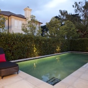 View of outdoor entertainment area, with pool, paving, backyard, estate, home, house, leisure, lighting, outdoor structure, property, real estate, swimming pool, villa, yard, brown