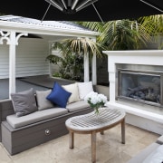 View of outdoor area with pool, paving, fountain, backyard, furniture, home, living room, outdoor structure, patio, gray