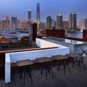 View of a contemporary boutique hotel in Shanghai. apartment, architecture, building, city, cityscape, condominium, downtown, metropolis, metropolitan area, mixed use, real estate, roof, sky, skyline, skyscraper, urban area, black, blue