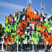 View of Pixel Building, with colorful exterior flags, art, graffiti