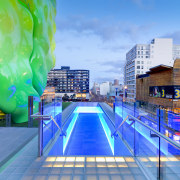 View of RMIT building in Melbourne with green architecture, blue, city, cityscape, daytime, downtown, landmark, leisure, leisure centre, metropolis, metropolitan area, real estate, reflection, sky, swimming pool, urban area, water, teal