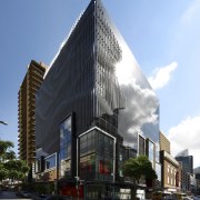 View of office tower with retail podium with architecture, building, city, commercial building, condominium, corporate headquarters, daytime, downtown, facade, headquarters, metropolis, metropolitan area, mixed use, neighbourhood, sky, skyscraper, tower block, teal, black