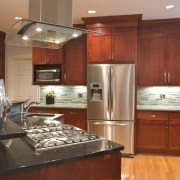 View of a wooden kitchen designed by Instinctive cabinetry, countertop, cuisine classique, hardwood, home, interior design, kitchen, real estate, room, brown, red