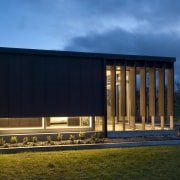 View of contemporary bach with terrace, sheltered courtyard architecture, corporate headquarters, facade, home, house, real estate, shed, sky, black, teal