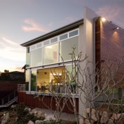 View of home with double height entrance, deck apartment, architecture, balcony, building, cottage, facade, home, house, property, real estate, residential area, roof, window, gray