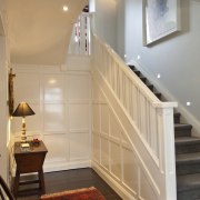 Interior view of traditional style home with white ceiling, daylighting, floor, flooring, furniture, handrail, hardwood, home, house, interior design, molding, real estate, room, stairs, wall, window, wood, wood flooring, gray, orange