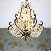 View of bathroom with floral wallpaper and dark-toned chandelier, light fixture, lighting, white, gray