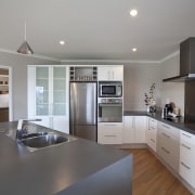 View of Platinum Homes show home with solid cabinetry, countertop, cuisine classique, interior design, kitchen, property, real estate, room, gray