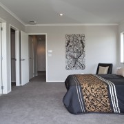 View of Platinum Homes show home with solid bed frame, bedroom, ceiling, floor, flooring, home, interior design, living room, property, real estate, room, wall, wood, gray