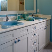 View of bathroom with white cabinetry and blue bathroom, bathroom accessory, bathroom cabinet, bathroom sink, blue, cabinetry, countertop, kitchen, room, sink, gray