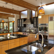 View of sunken open-plan kitchen with wooden cabinetry, cabinetry, countertop, cuisine classique, interior design, kitchen, real estate, brown, orange