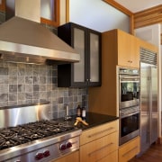 View of sunken open-plan kitchen with wooden cabinetry, cabinetry, countertop, cuisine classique, hardwood, home appliance, interior design, kitchen, room, brown