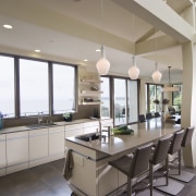 View of neutral-toned kitchen and dining space, featuring countertop, interior design, kitchen, property, real estate, window, gray