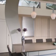 View of neutral-toned kitchen and dining space, featuring architecture, ceiling, daylighting, furniture, interior design, product design, table, gray