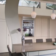 View of neutral-toned kitchen and dining space, featuring ceiling, furniture, interior design, kitchen, office, product design, gray