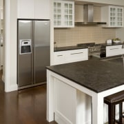 View of kitchen with wooden flooring, dark benchtops cabinetry, countertop, cuisine classique, floor, flooring, hardwood, home appliance, interior design, kitchen, laminate flooring, room, wood flooring, brown, gray