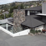 View of DJ Hewitt house built on a architecture, facade, house, outdoor structure, property, real estate, roof, siding, gray