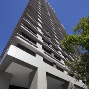 View of high rise office tower with wooden apartment, architecture, brutalist architecture, building, commercial building, condominium, corporate headquarters, daytime, facade, headquarters, house, landmark, metropolis, metropolitan area, mixed use, real estate, residential area, sky, skyscraper, tower block, black, blue