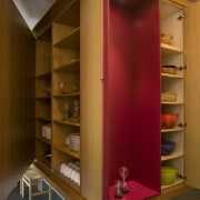 View of modernist style kitchen with wooden cabinetry bookcase, cabinetry, closet, furniture, interior design, room, shelf, shelving, brown