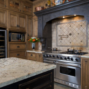 View of kitchen with aged look, featuring internally cabinetry, countertop, cuisine classique, flooring, hardwood, home appliance, interior design, kitchen, kitchen appliance, room, black, brown, gray