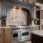 View of kitchen with aged look, featuring internally cabinetry, countertop, cuisine classique, floor, flooring, hardwood, home, home appliance, interior design, kitchen, kitchen appliance, kitchen stove, room, wood flooring, gray, black