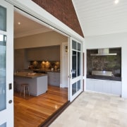 View of BBQ set in the covered deck ceiling, countertop, floor, flooring, hardwood, house, interior design, kitchen, laminate flooring, living room, real estate, window, wood flooring, white, brown