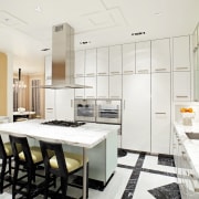 The Calacatta marble-topped island in this kitchen sits ceiling, countertop, floor, flooring, interior design, kitchen, room, white