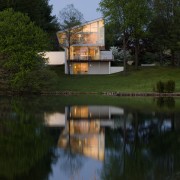 View of contemporary home. - View of contemporary bayou, body of water, home, house, lake, landscape, nature, plant, pond, real estate, reflection, reservoir, river, sky, tree, water, water resources, waterway, wetland, black, brown