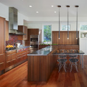 View of a kitchen which combines commerical touches cabinetry, countertop, cuisine classique, floor, flooring, hardwood, interior design, kitchen, laminate flooring, real estate, room, wood, wood flooring, gray, red