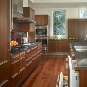 View of a kitchen which combines commerical touches cabinetry, countertop, cuisine classique, floor, flooring, hardwood, interior design, kitchen, laminate flooring, real estate, room, wood, wood flooring, brown, gray