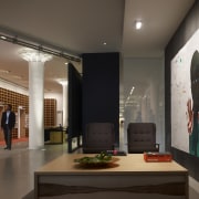 View of two chairs and a desk at ceiling, exhibition, interior design, lobby, brown, black