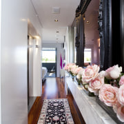 View of hallway with rug and flowers in aisle, ceiling, floor, flooring, interior design, room, gray