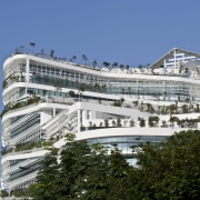 View of Solaris, an ecoskyscraper designed by Ken architecture, building, condominium, corporate headquarters, cruise ship, daytime, facade, headquarters, hotel, metropolitan area, mixed use, passenger ship, sky, watercraft, teal