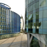 View of the Shanghai International Cruise Terminal. architecture, building, commercial building, condominium, corporate headquarters, daylighting, daytime, facade, glass, headquarters, metropolis, metropolitan area, mixed use, reflection, residential area, skyscraper, structure, tower block, urban area, gray