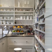 Creating a new tradition This kitchen references the countertop, kitchen, pantry, shelf, shelving, gray