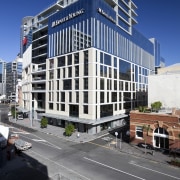 Exterior view of a building at the Britomart apartment, architecture, building, city, commercial building, condominium, corporate headquarters, daytime, downtown, facade, headquarters, metropolis, metropolitan area, mixed use, neighbourhood, real estate, residential area, sky, skyscraper, tower block, urban area, blue