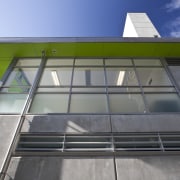 View of windows at Mt Eden prison by architecture, building, commercial building, corporate headquarters, daylighting, facade, glass, house, roof, gray