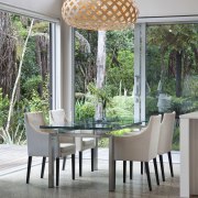 View of dining area with decorative light feature. chair, dining room, furniture, home, interior design, outdoor structure, patio, table, window, gray