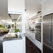The kitchen is designed by Robyn Labb Kitchens. countertop, home appliance, interior design, kitchen, refrigerator, gray