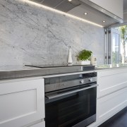The kitchen is designed by Robyn Labb Kitchens. cabinetry, countertop, floor, interior design, kitchen, wall, gray