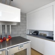 This kitchen features stainless steel benchtops. It was cabinetry, countertop, cuisine classique, floor, home appliance, interior design, kitchen, kitchen appliance, kitchen stove, room, gray