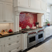 Arched openings. Red splash back. Limestone floors. White cabinetry, countertop, cuisine classique, floor, flooring, home, home appliance, interior design, kitchen, kitchen appliance, kitchen stove, room, tile, gray